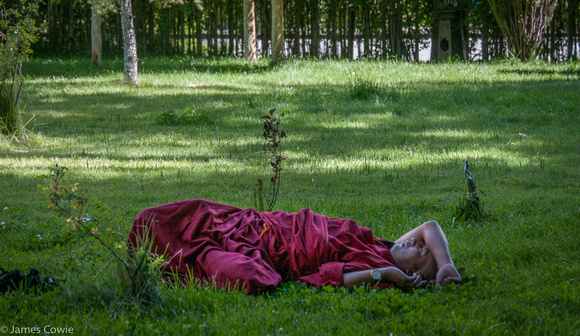 A monk having a rest in the gardens.