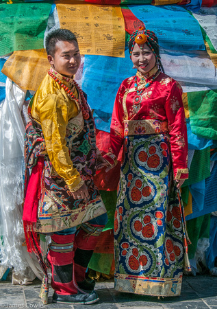 A bride and groom posing for photos in the market.