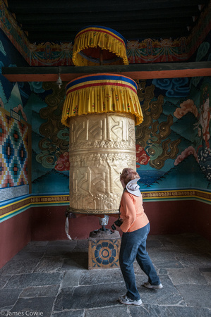 Wendy turning the giant prayer wheel at the entrance of the temple.