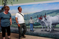 Vickie and Minor with mural at our lunch stop on the way to Monteverde